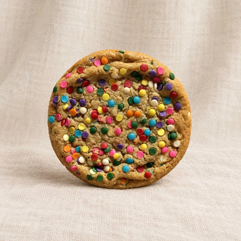 funfetti cookie on a textured fabric background