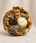 smores cookie on a plain textured background