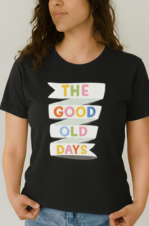 Person wearing a black t-shirt with 'The Good Old Days' text design.
